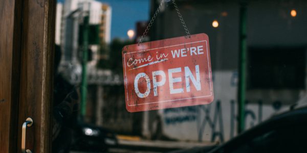 "We're Open" sign on door