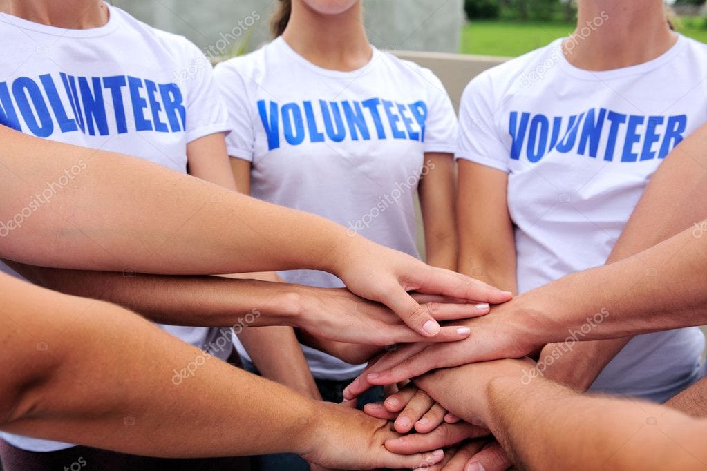 Volunteers with hands in