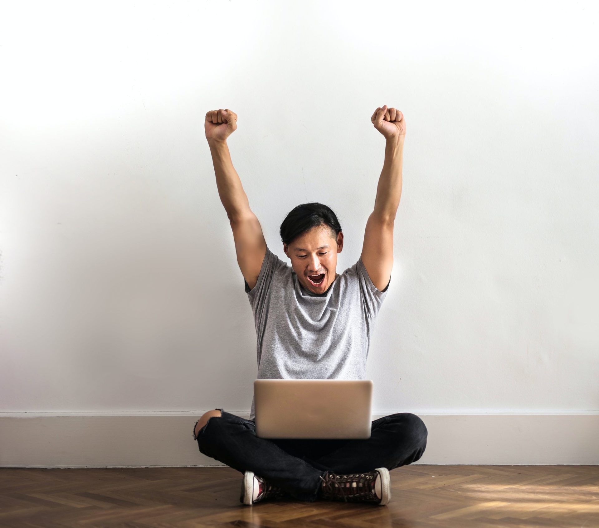 Man celebrating with laptop