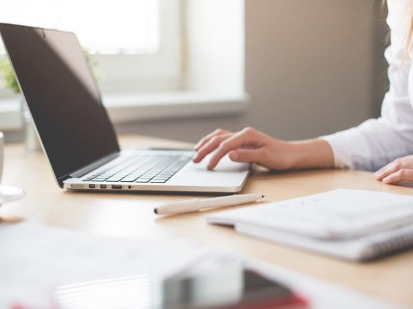 Woman working at desk with a laptop