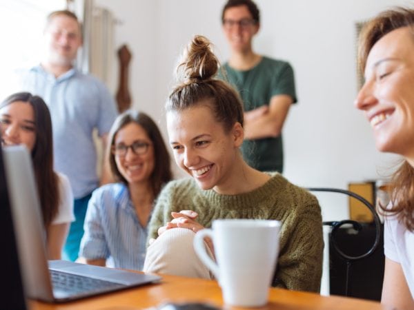 People smiling while looking at screen