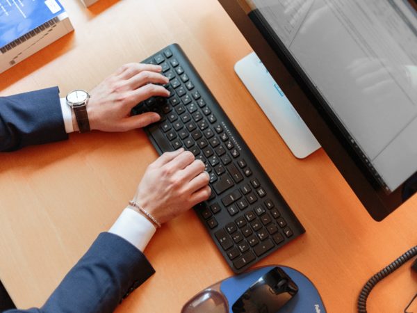 Hands typing on a keyboard